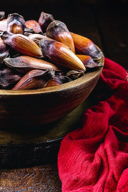 pine nuts in rustic wooden bowl traditional brazilian winter food