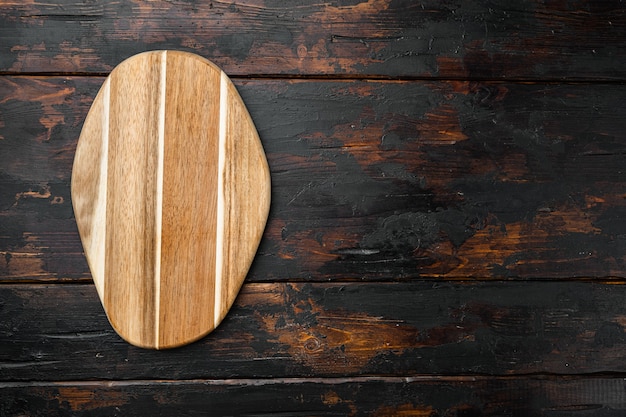 Pine wooden cutting board set, on old dark  wooden table background, top view flat lay , with copy space for text or your product