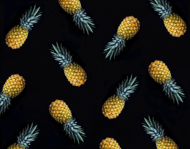 Pineapple on the black background Pattern Flat lay