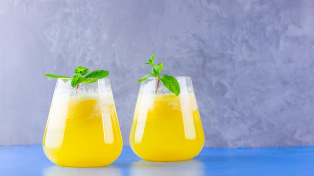 Pineapple juice on a blue gray background Juice for detox in the glass Pineapple smoothie