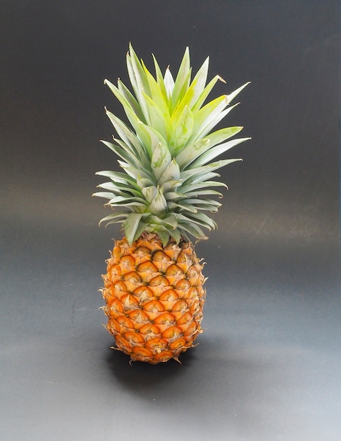 Pineapple ripe isolated dark background