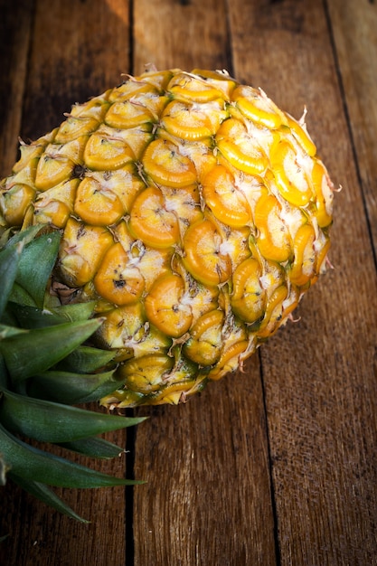 Pineapple on wooden background.