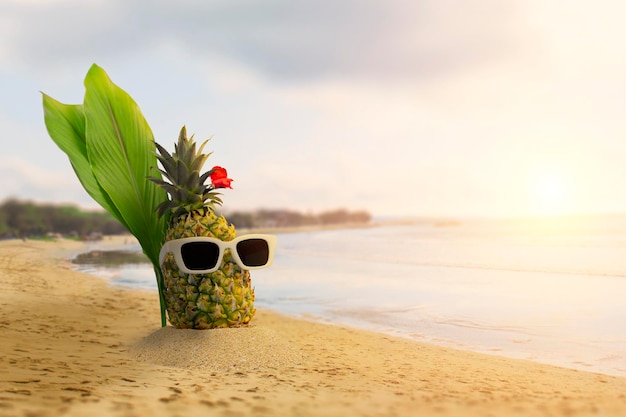 PinePineapple with sunglasses and headphones at tropical beach