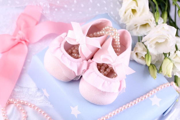 Pink baby boots with gift closeup