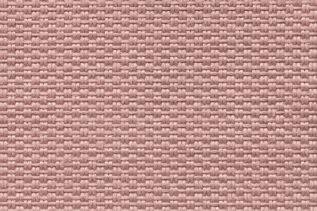 Pink background of dense woven bagging fabric, closeup. Structure of the textile macro.