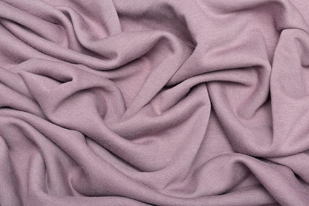 Pink background texture of knitted wool. Knitted fabric.