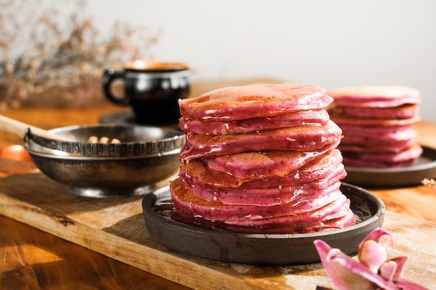 Pink beet pancakes poured honey