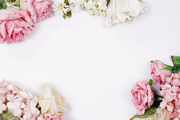 Pink and beige roses on white background. Wedding's background.