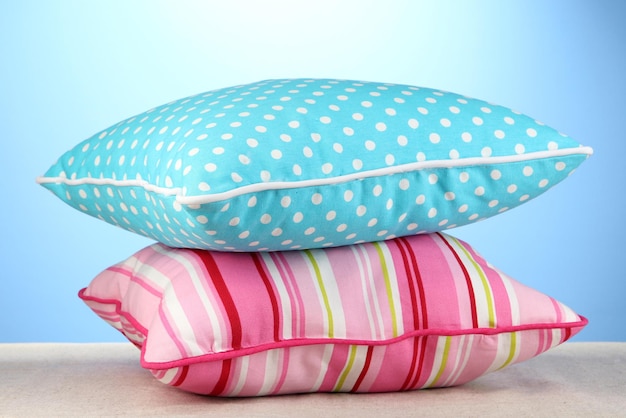 Pink and blue bright pillows on blue background