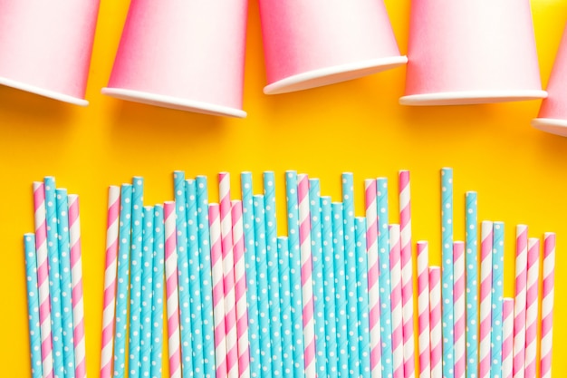 Pink and blue paper straws and pink cups