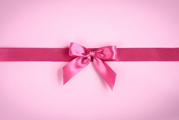 Pink bow on pink background.