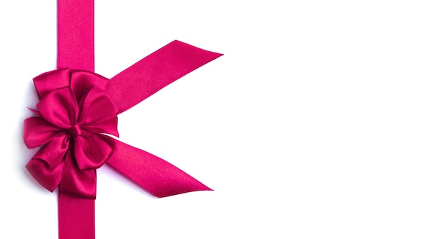 Pink bow and ribbon on a white background