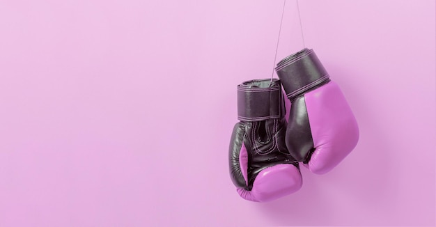 Pink boxing gloves on a pink background Symbol of the struggle for women rights and against breast cancer Template Copy space for text mockup