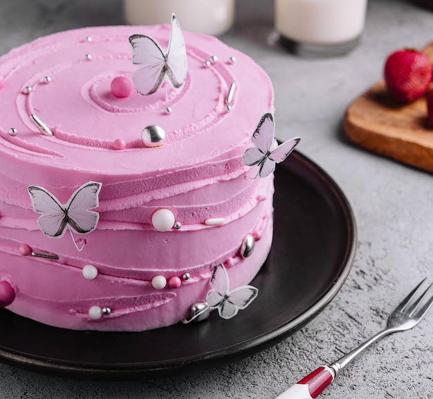 Pink cake decoration in the form of butterflies