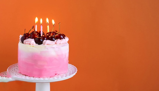 A pink cake with a bunch of candles on it