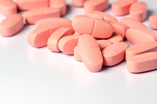 Pink calcium tablets on a white background Copy space