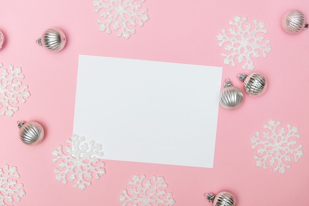 Pink christmas background with snowflakes decoration balls and empty blank for text flat lay copy space