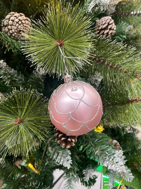 pink Christmas ball on whtie tree background. Happy New year and Merry Christmas  2023