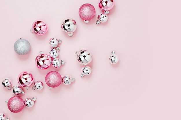 Pink Christmas balls background. Flat lay, top view