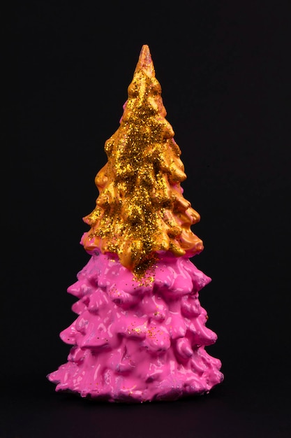 Pink Christmas tree on a black background Happy Holidays Minimal new year concept