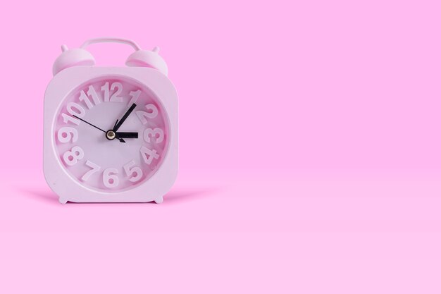 Pink Clock Isolated On Pastel Pink Background. Wall clock