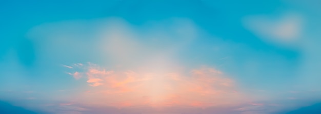 Pink clouds in blue clear skies on a summer evening calm quiet gentle clouds wide panorama