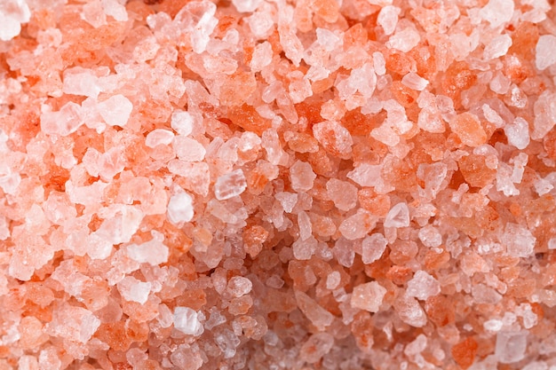 Pink coarse salt crystals on blue table