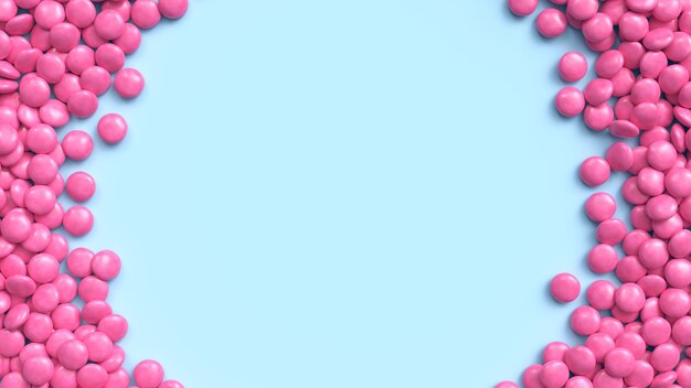 Pink coated chocolate candies arranged in circle frame on blue pastel background