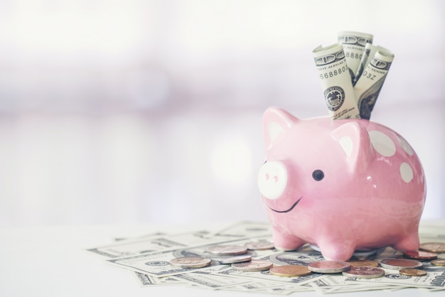 Pink color piggy bank on white table