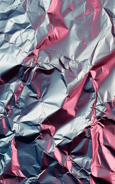 Pink colored crumpled foil texture