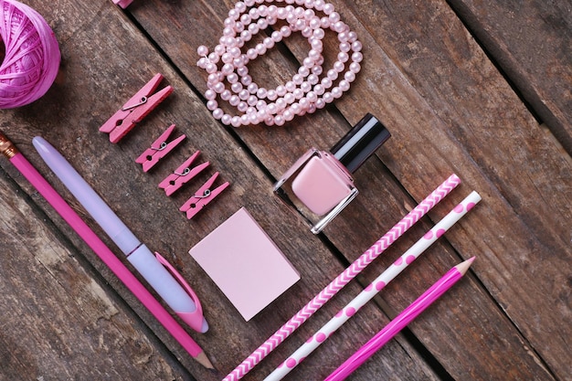 Pink colour flat lay composition on wooden background top view