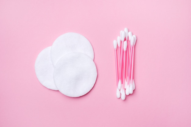 Pink cotton buds and cotton swabs on pink.