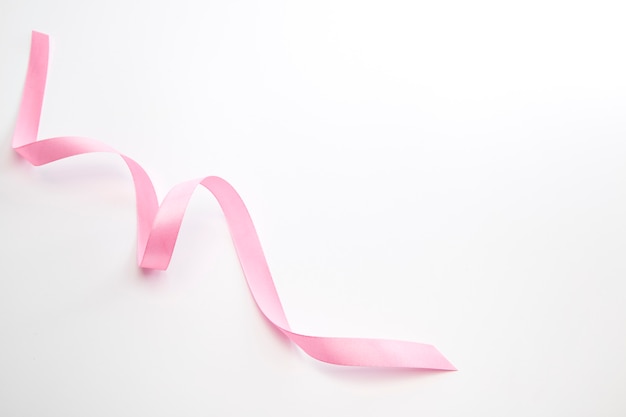 Pink curly ribbon isolated on white