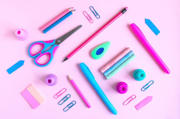 Pink desk with variety of rose and blue school supplies