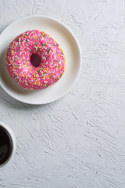 Pink donut with coffee