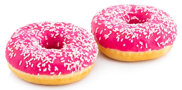 Pink donut with colorful sprinkles isolated on white background.