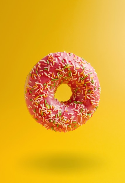 Pink donut on yellow background