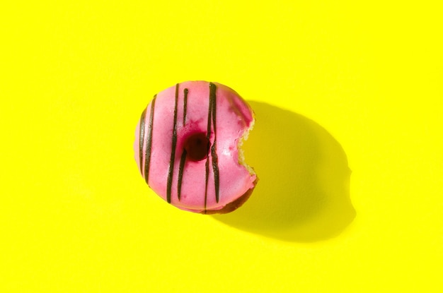 Pink donut on yellow background