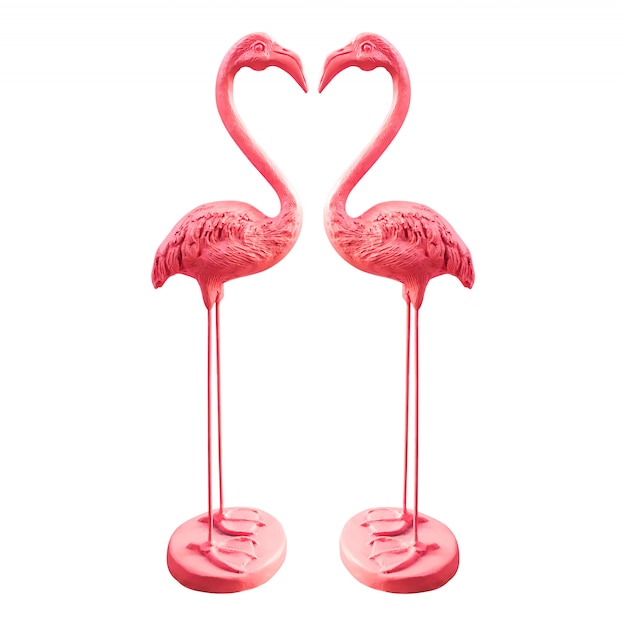 Pink flamingo statues isolated on white.