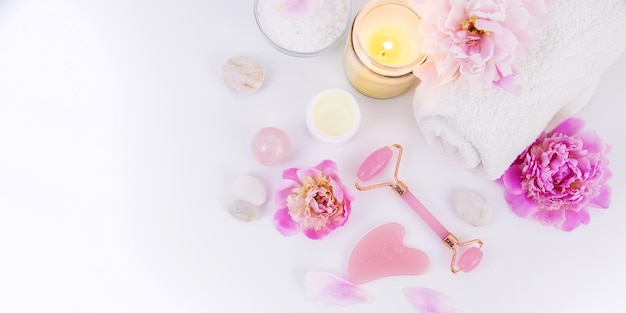 Pink flowers on white background spa facial Selective focus