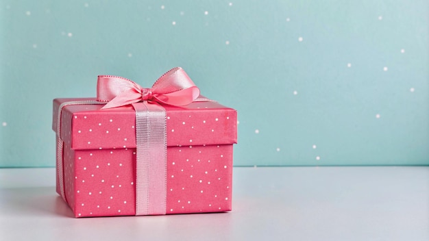 a pink gift box with a pink bow on it