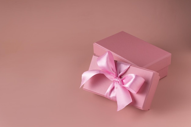 Pink gift boxes on beige background