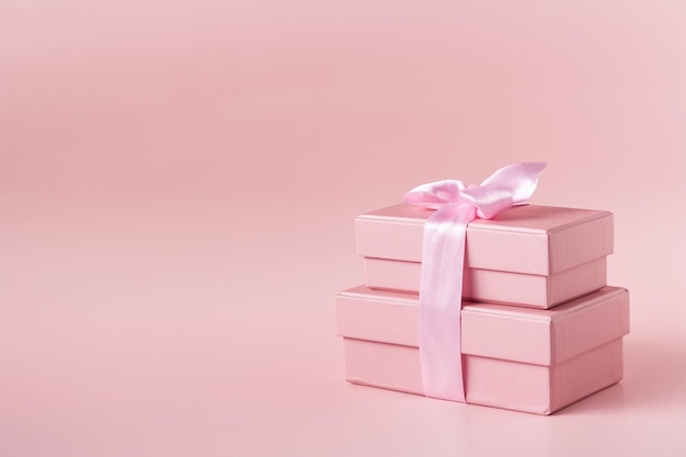 Pink gift boxes on pink background copy space