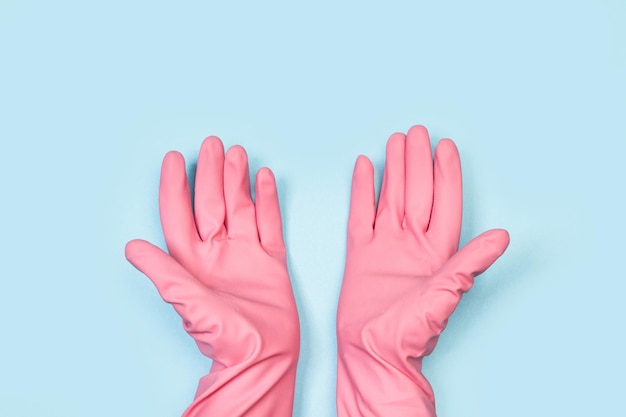 Pink gloves on a blue background with the word cleaning on it