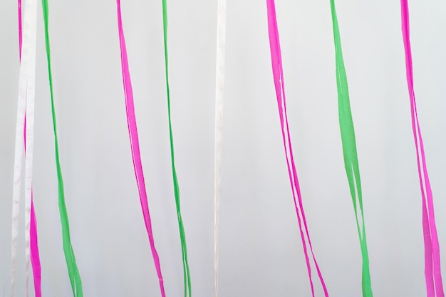 Pink green white ribbons in vertical line background in minimal celebration event