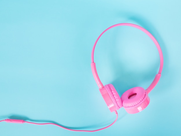 pink headphone on blue background