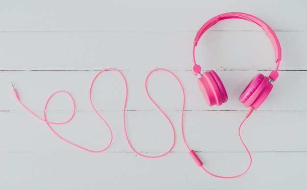 Pink headphones on the wooden floor