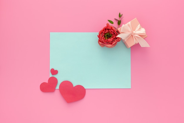 Pink hearts, handmade pink gift box, red roses and writing pad