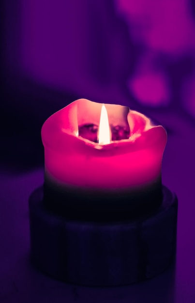 Pink holiday candle on purple background luxury branding design and decoration for Christmas New Years Eve and Valentines Day