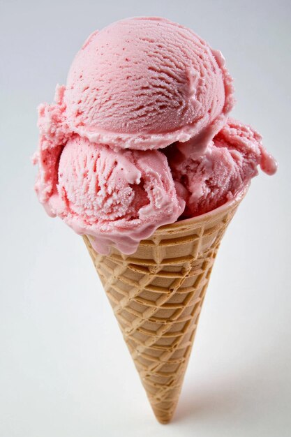 Photo the pink ice cream is served on a crispy waffle cone isolated against a white background